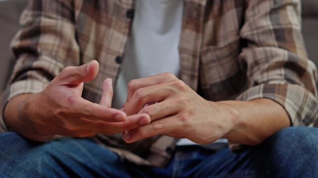 Close-up of husband hands slowly removing gold wedding ring