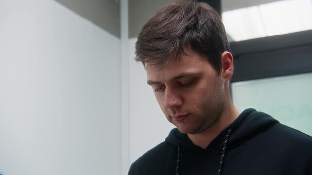 Male patient stepping onto a medical weighing scale during a routine health check in a clinic, focusing on body weight measurement and wellness monitoring.