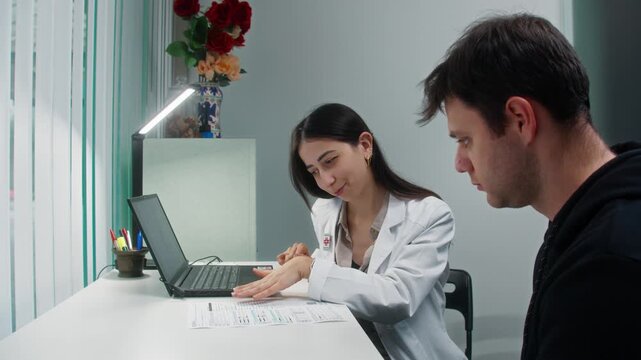 Female doctor reviewing medical documents with a male patient during a consultation, captured with a smooth backward camera movement in a modern clinic office.