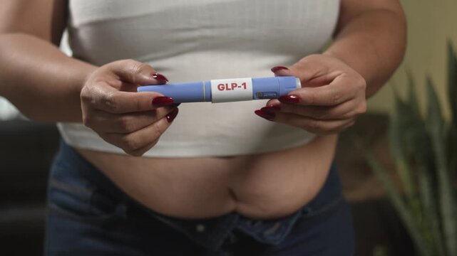 Female hands preparing semaglutide GLP-1 pen for self-injection, metabolic health and weight loss therapy