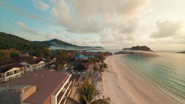 Fast cinematic FPV drone footage cruising low over the sandy coastal beach and ocean waves of Redang Island during a beautiful golden sunrise