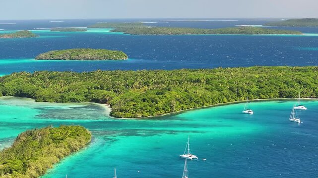 Paradise small island and boats with small strait. Vava'u archipelago, Tonga, South Pacific. Drone