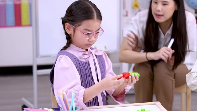Elementary School Girl Solving Math with Colorful Counting Blocks