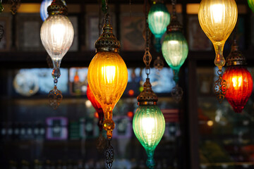 Colorful hanging lanterns glowing lights decorative oriental style festive ambiance © Nastya