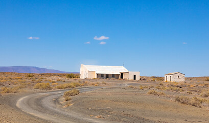 Old farm buildings in Karoo desert landscape © Sunshine Seeds