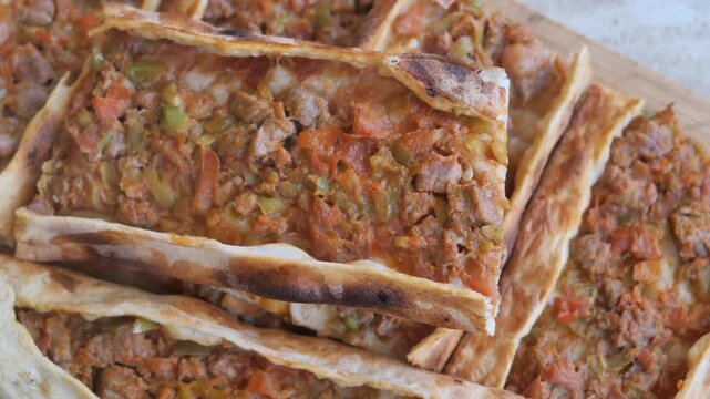 Turkish pitta known as pide homemade baking. Traditional flatbread or pizza with meat filling. Delicious turkish food close up video
