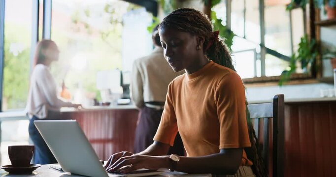 Laptop, remote work and woman in coffee shop, reading review and feedback for social media marketing. Computer, cafe and freelancer typing email for sponsorship, post update and creative campaign