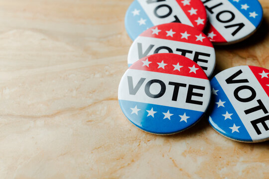 several vote badges scattered on a table