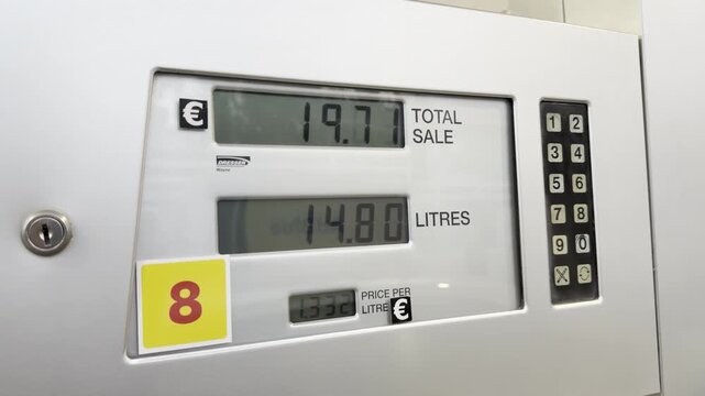 Digital dispenser screen with sale total and litre data at gas station during regional oil price surge. Pump meter fits editorial, fuel crisis and transport cost inflation visuals.