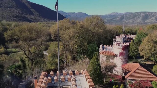 Cinematic drone shot of a unique boutique hotel designed like a medieval castle. Nestled in the lush forest of Komnina, Xanthi. Perfect for travel, luxury tourism and fairytale storytelling