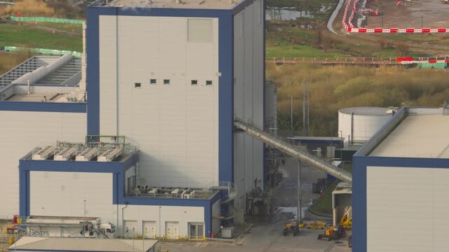 Industrial biomass energy plant converting recycled wood waste and timber scraps into clean renewable electricity. Sustainable infrastructure and green energy production at a modern power station.
