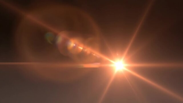 Warm sunset-inspired flare transition with glowing tangerine and copper tones cutting diagonally across a deep charcoal gradient background, elongated light beam with soft chromatic fringes and