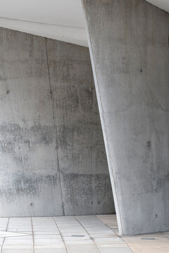 Minimal architecture in modern concrete structure featuring a column with clean lines and shadow highlighting abstract texture for design background