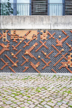 Abstract architecture wall and brick facade showing urban pattern texture above cobblestone pavement forming a graphic background for modern design