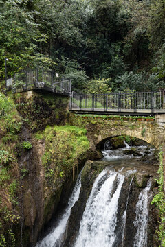 lower waterfall with stone bridge and stream cascate del varone parco grotta trentino alto adige italy