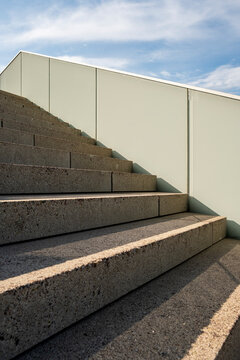 Minimal concrete stairs under open sky with bold shadow in modern abstract architecture expressing up direction and growth with clean lines and geometry