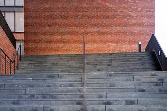 Symmetry of stairs on brick wall in minimal urban architecture with abstract lines showing down direction while keeping progress concept in clean space