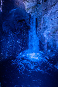 waterfall close up with blue light rock texture cascate del varone underground cave trentino alto adige italy