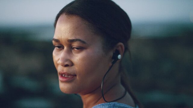 Face, fitness and music with woman on beach for recovery or rest from training fatigue, Earphones, exercise and exhausted with runner person outdoor at coast for health, cardio workout or wellness