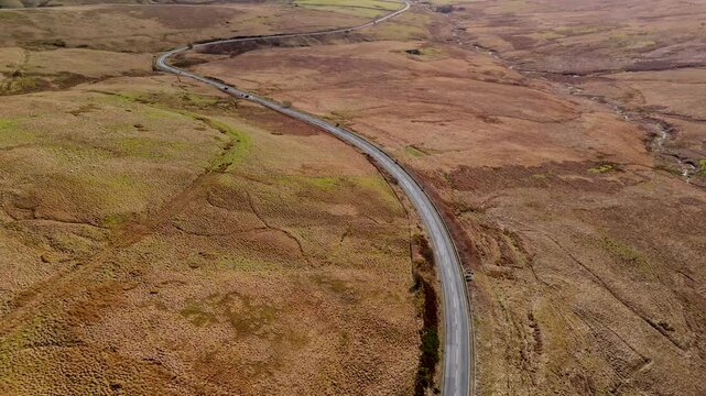 Carter Bar Scotland: 14th March 2026: Drone view of the A68 road winding through Cheviot Hills, on the Anglo-Scottish border on a sunny Springtime day