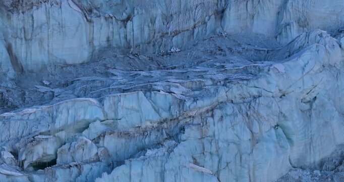Close aerial drone view of glacier snow chunk formations and compact ice structures near Lobuche Peak in the high-altitude Himalayan terrain of the Everest region, Nepal.