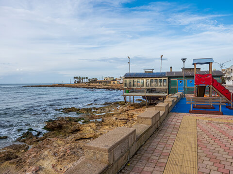 Ugento waterfront with playground and rocky shoreline