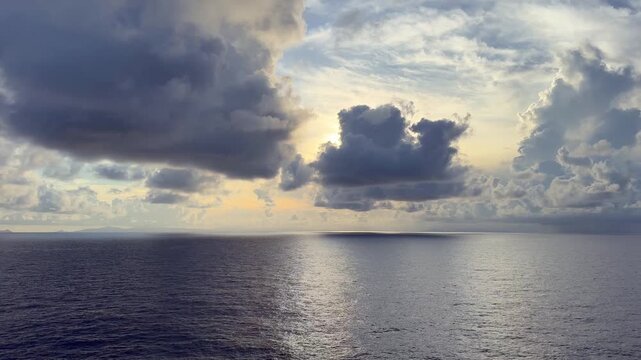 Panning from right to left across calm seas in the Mozambique Channel between Madagascar and the African coast with the French Comoros in the distance.