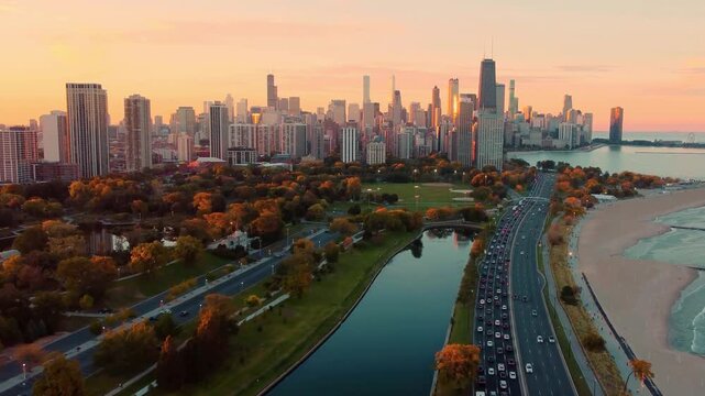 Stunning aerial drone footage of Chicago's iconic skyline at sunset, with golden light illuminating skyscrapers like the Willis Tower. Foreground features Lake Michigan's beach.