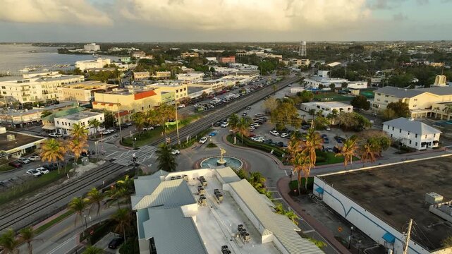 A scenic aerial view highlights the vibrant downtown district of Stuart as sunset light reflects across the nearby waterfront.