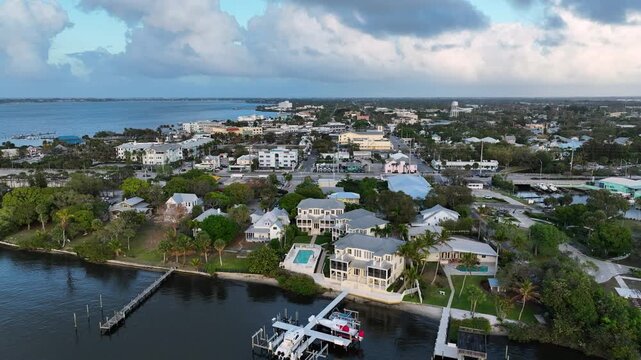 A tranquil drone shot glides above the waterfront neighborhood behind downtown Stuart on the St. Lucie River.