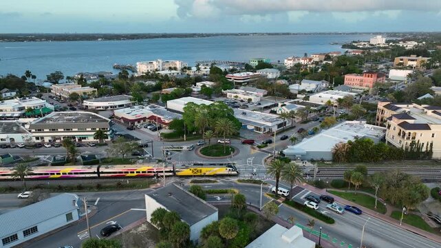 A high-altitude clip of downtown Stuart with a train crossing through the town at sunset.