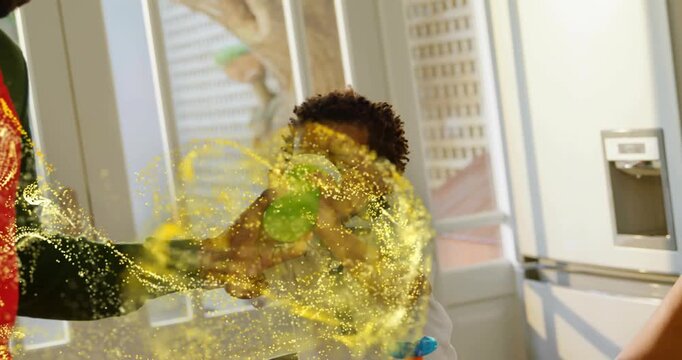 Parent offering and steadying sippy cup helping child drinking as gold swirl wrapping for parenting