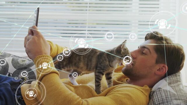 Man reclining holding phone, cat stepping onto chest causing technology HUD expanding, man nuzzling