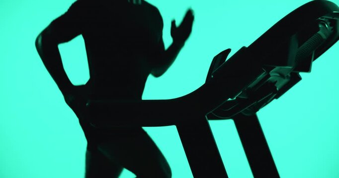 Running, treadmill or man with fitness, green screen or cardio workout on studio background. Runner, energy or healthy person with machine, equipment for exercise or challenge for wellness or speed