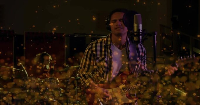 Vertical video: Singer strumming first chord to start studio take, singing over golden lower sweep