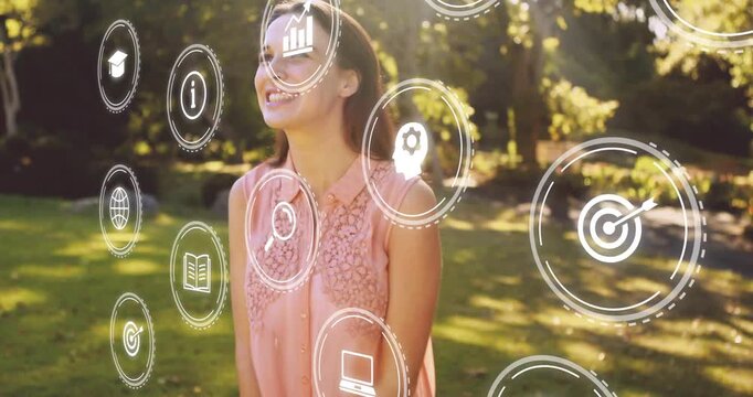 Woman spinning in sunny park starting AR icons layering frame showing search laptop for creatives