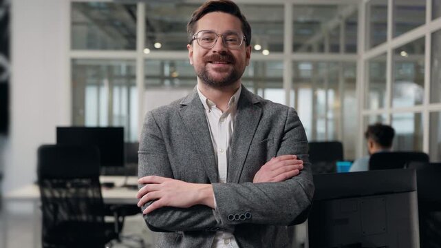 Thinking Caucasian business man smiling happy looking at camera crossed hands posing at office European businessman think smile joyful satisfied male crossing folded arms standing in corporate agency