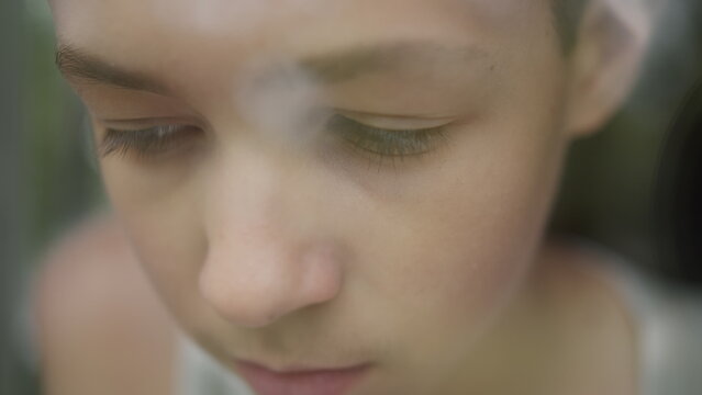 Pensive Young Woman Looking Down with Soft Focus, have fun and enjoy