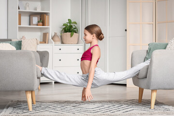 Obraz premium Cute girl doing gymnastics at home