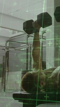 Vertical video: Man lying on bench pressing dumbbell from chest for fitness, HUD grid showing form