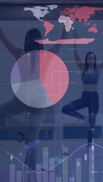 Vertical video: Two women raising arms shifting weight causing yoga data overlay tracking balance
