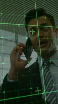 Vertical video: Camera pulling closer as Asian man on phone talking HUD aligning and showing lounge