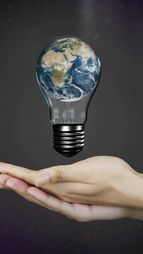 Vertical video: Pair of hands cupping, causing hovering bulb with rotating globe, showing tech idea