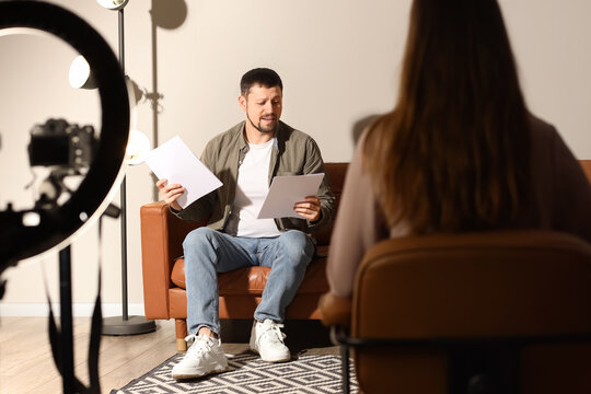 Male actor with film script and producer acting in audition room