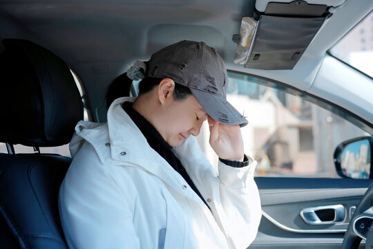Tired Person with Headache in Car Interior