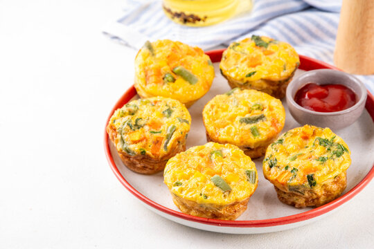 Loaded egg bites with spring vegetables, spinach, carrot, tomato, green beans,  healthy vegan diet food recipe for brunch, breakfast, Simple and quick baked eggs balanced snack