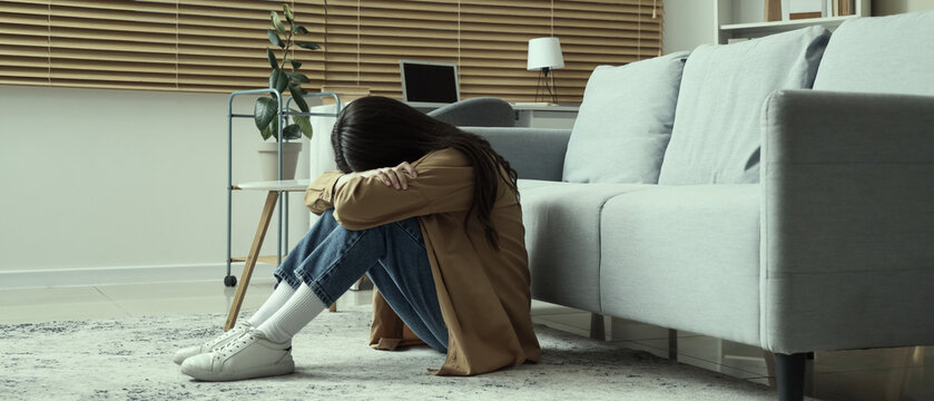 Portrait of worried young woman  at home