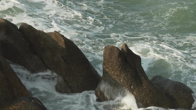 Ocean waves over big rocks