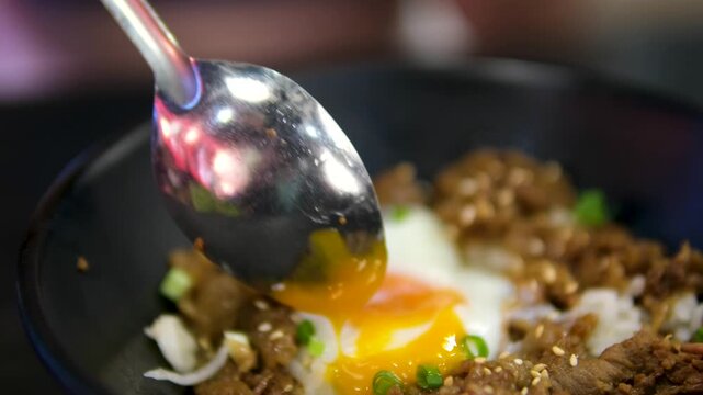 break an egg with a runny yolk with a spoon dish made by frying cooked rice in oil. A food found in China and other regions where rice is a staple food. It is called fried rice.