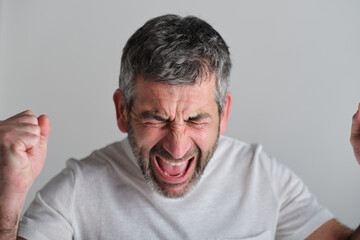 Fototapeta premium headshot of Angry aggressive man screaming expressing frustration and fury